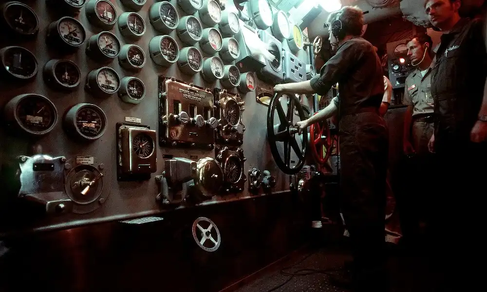 Sailors operating engine room controls aboard the battleship USS New Jersey